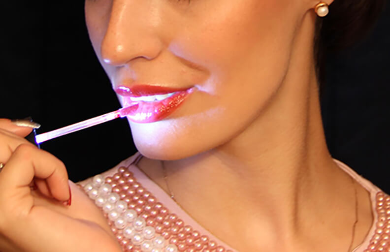 Woman applying new Cosmoholic liquid lipstick