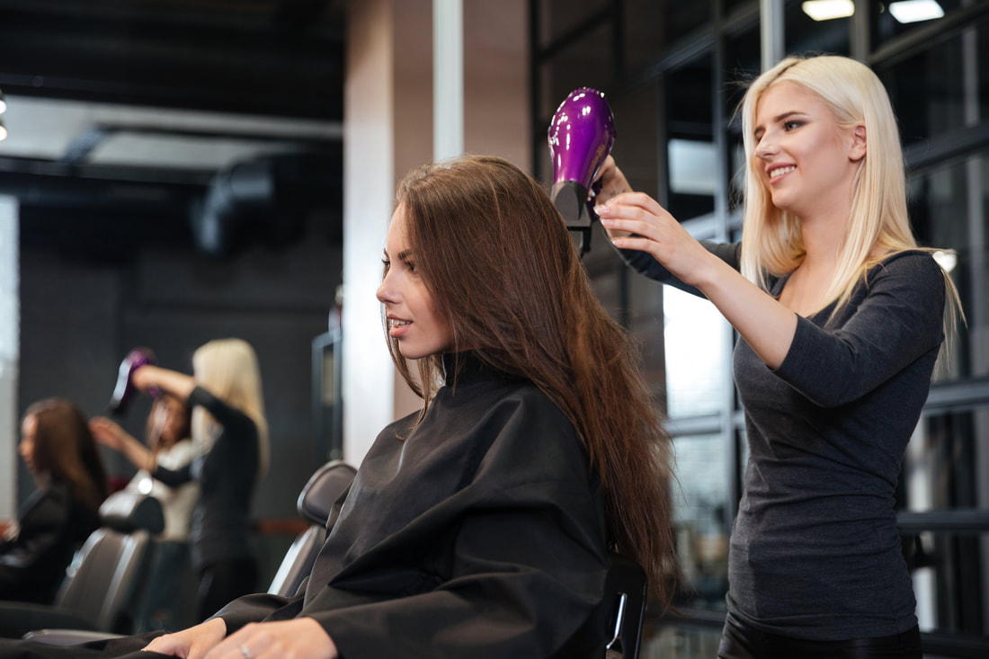 image of female stylist and client working at salon